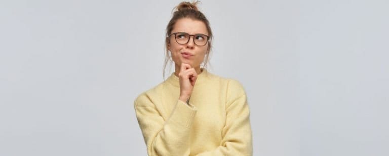 ¿Qué aprendemos los Psicólogos en terapia? 2 Mujer con jersey amarillo se lleva el dedo a la barbilla y mira arriba en actitud reflexiva